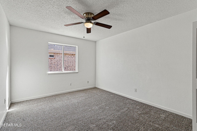 spare room featuring carpet flooring, baseboards, a textured ceiling, and a ceiling fan