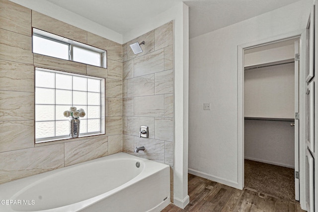 bathroom with wood finished floors and baseboards