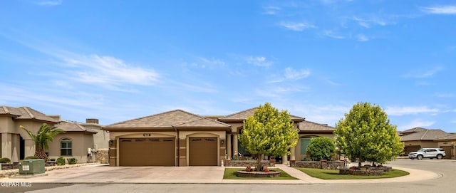 view of front of property with a garage, stucco siding, concrete driveway, central AC unit, and a tiled roof