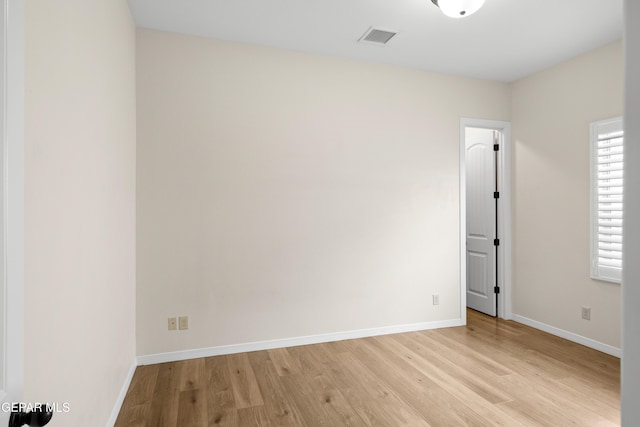 unfurnished room with light wood-style floors and baseboards