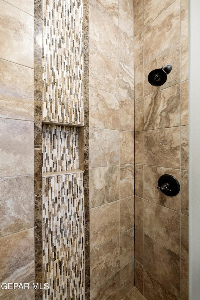 full bath with a tile shower