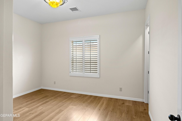 empty room with light wood-style flooring and baseboards