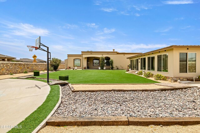 rear view of property featuring stucco siding