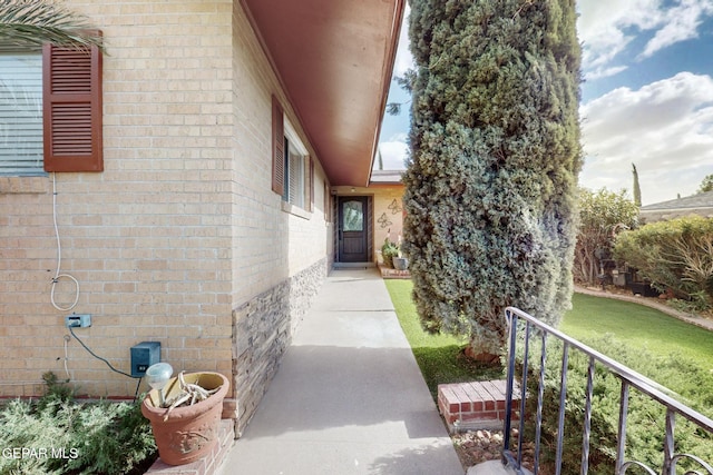 entrance to property featuring brick siding