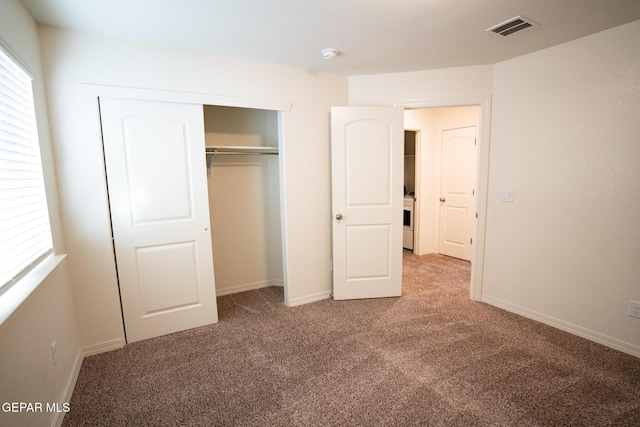 unfurnished bedroom with baseboards, visible vents, carpet floors, and a closet