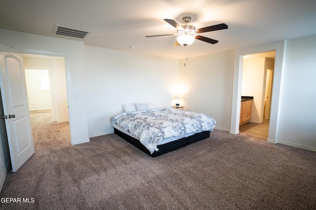 bedroom featuring a ceiling fan, light colored carpet, visible vents, and baseboards