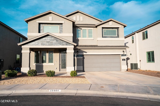 view of front of house featuring cooling unit, stucco siding, an attached garage, and concrete driveway