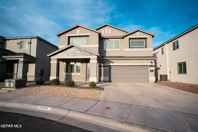view of front of house featuring cooling unit, a garage, driveway, and stucco siding
