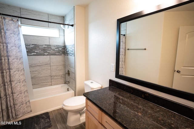 bathroom featuring vanity, toilet, wood finished floors, and shower / bath combo
