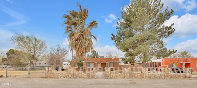 exterior space with a gate and a fenced front yard