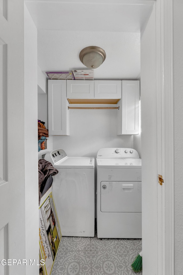 laundry area featuring cabinet space and washer and clothes dryer