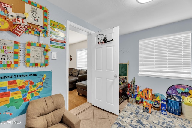 recreation room featuring tile patterned floors