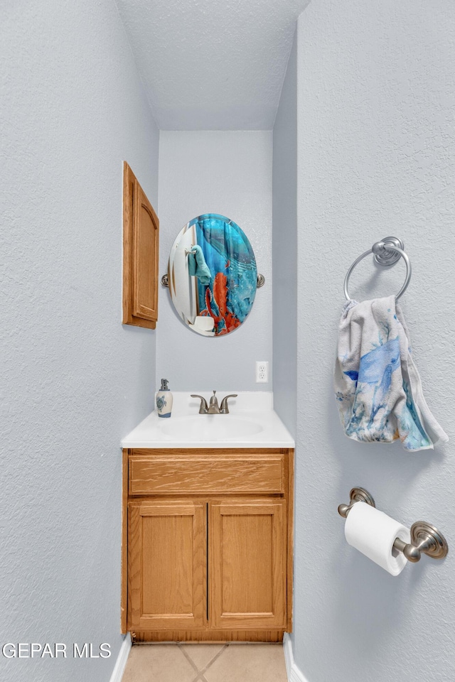 bathroom with a textured ceiling and vanity