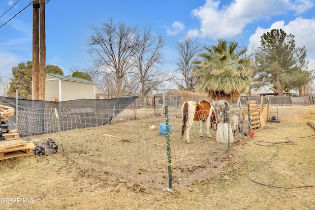 view of yard featuring an outbuilding and fence