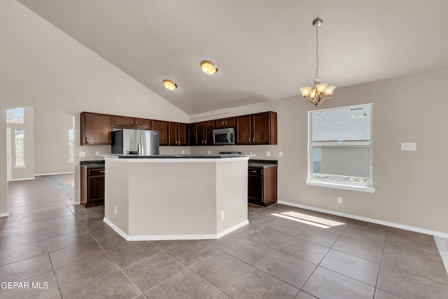 kitchen featuring light tile patterned floors, a notable chandelier, a healthy amount of sunlight, and stainless steel appliances