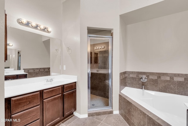 bathroom with a garden tub, a stall shower, vanity, and tile patterned flooring