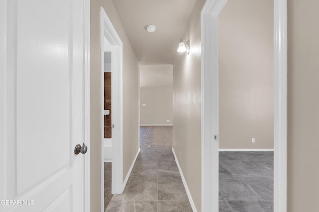 hall featuring baseboards