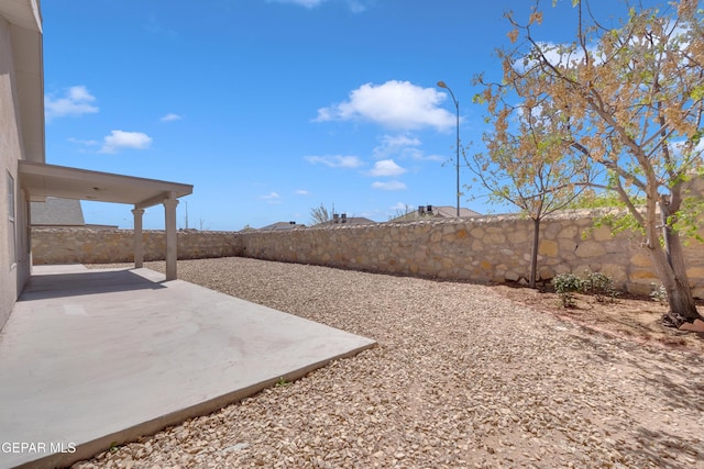 view of yard with a fenced backyard and a patio area