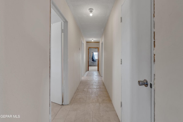 corridor featuring a textured ceiling
