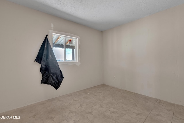 spare room with a textured ceiling