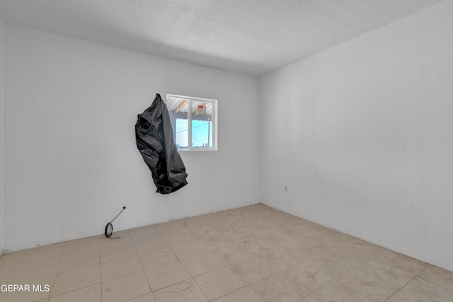 empty room featuring a textured ceiling