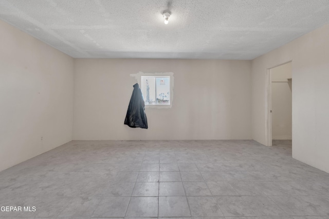 empty room with a textured ceiling