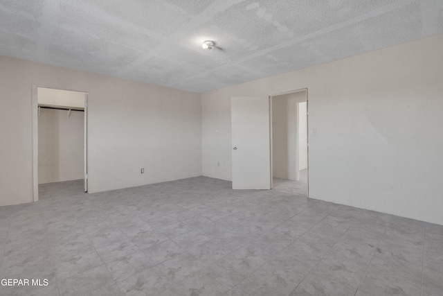unfurnished bedroom with a textured ceiling