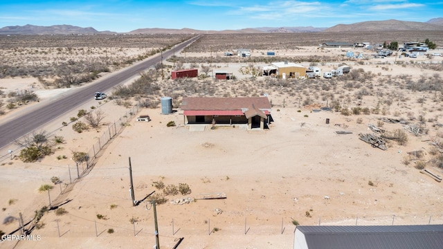 drone / aerial view featuring a desert view and a mountain view