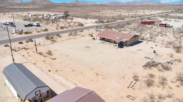 aerial view featuring a mountain view and view of desert