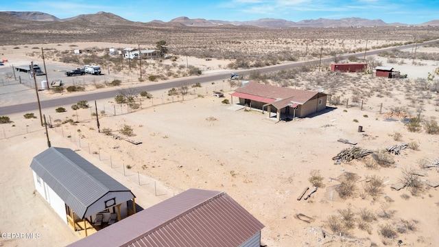birds eye view of property featuring a mountain view and a desert view