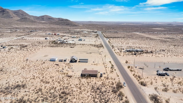 birds eye view of property featuring a mountain view, view of desert, and a rural view