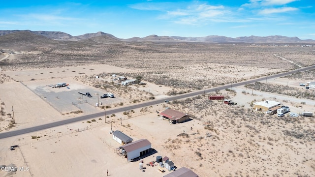 aerial view featuring a mountain view and a desert view