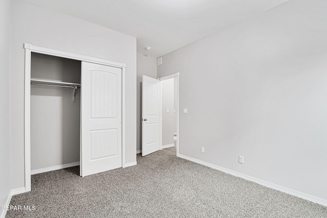 unfurnished bedroom with baseboards, a closet, and carpet floors