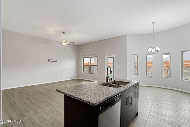 kitchen with dishwasher, open floor plan, a sink, and ceiling fan with notable chandelier