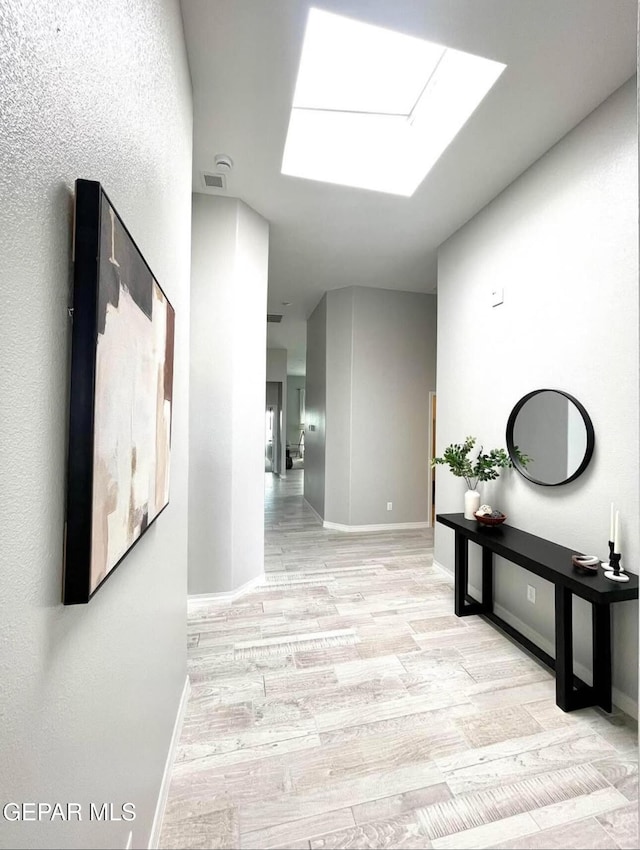 3897 Surmise St, El Paso, TX 79938 - corridor with light wood-style floors, baseboards, and a skylight