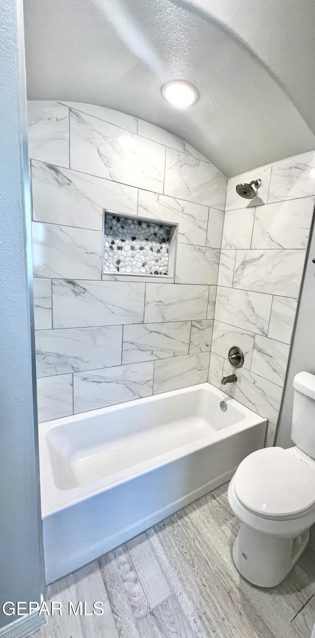 3897 Surmise St, El Paso, TX 79938 - full bath with tub / shower combination, toilet, a textured ceiling, and wood finished floors