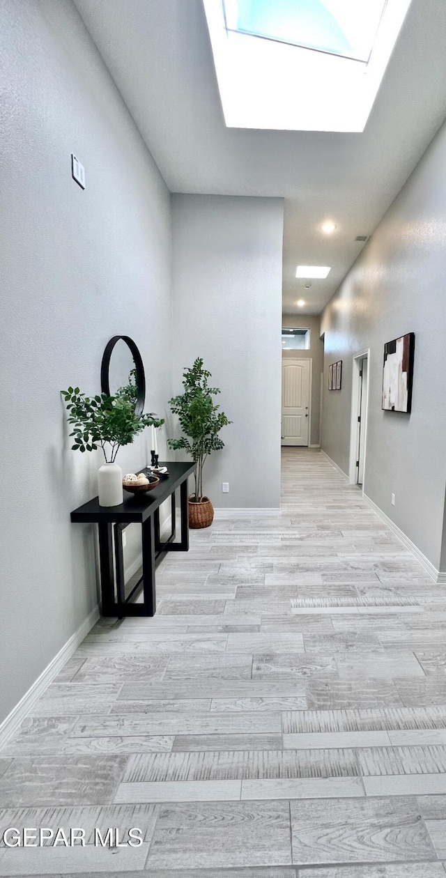 3897 Surmise St, El Paso, TX 79938 - hallway featuring a skylight, baseboards, and wood finished floors