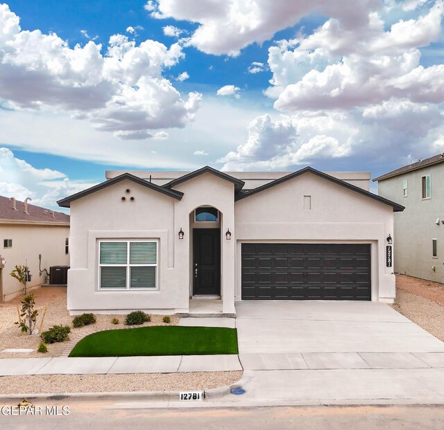 3897 Surmise St, El Paso, TX 79938 - ranch-style house with a garage, concrete driveway, stucco siding, and a front yard