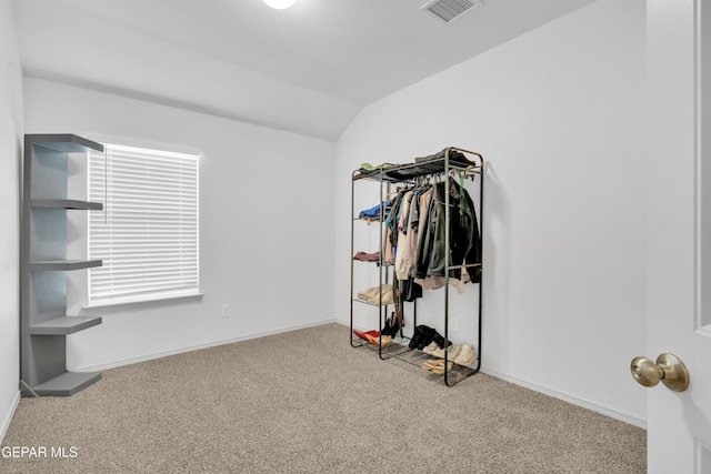 carpeted bedroom featuring visible vents, baseboards, and vaulted ceiling