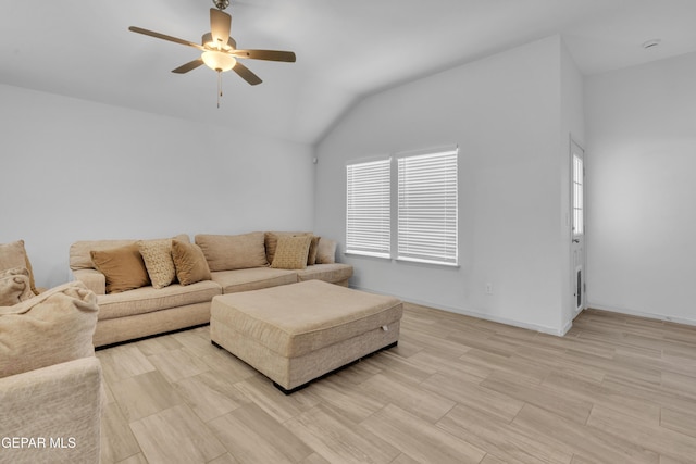 living area featuring light wood-style floors, vaulted ceiling, a ceiling fan, and plenty of natural light
