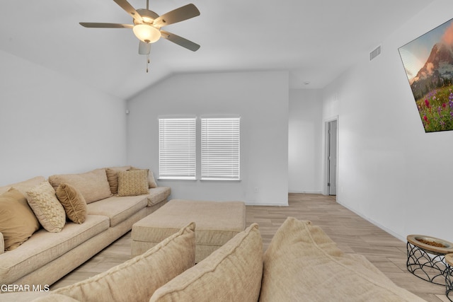 living room featuring baseboards, vaulted ceiling, light wood-type flooring, a ceiling fan, and visible vents