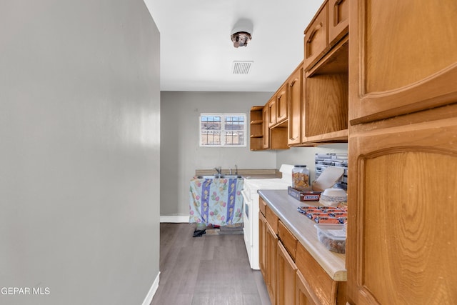 2413 Copper Ave Unit 79930, El Paso, TX 79930 - laundry room featuring baseboards, wood finished floors, and cabinet space