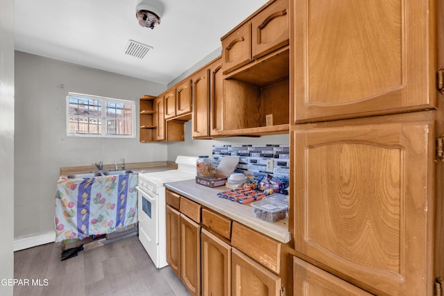 2413 Copper Ave Unit 79930, El Paso, TX 79930 - kitchen featuring white electric range, open shelves, light countertops, light wood finished floors, and a sink
