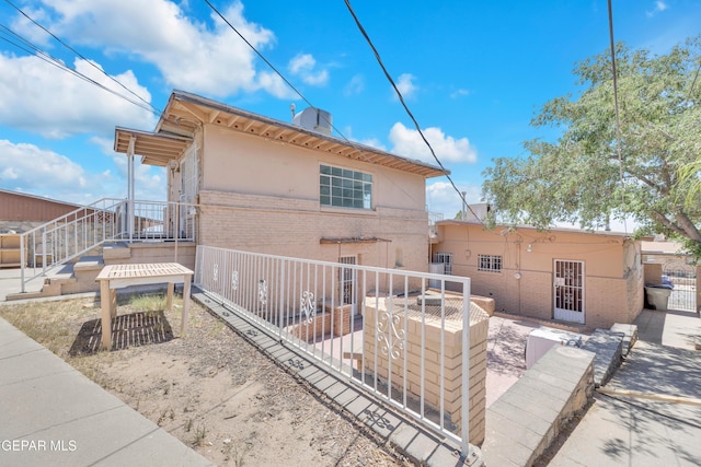 2413 Copper Ave Unit 79930, El Paso, TX 79930 - rear view of property with brick siding, fence, and stucco siding