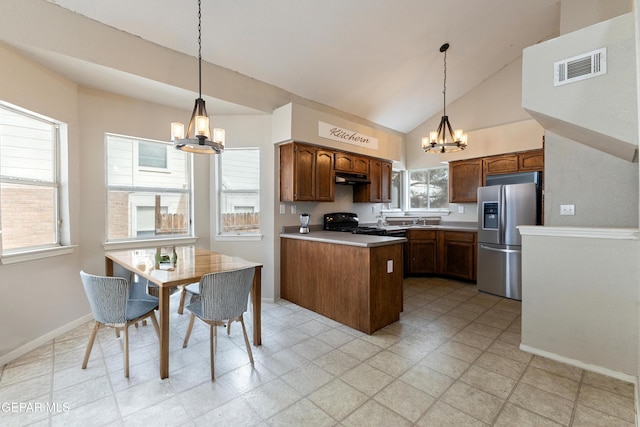 10892 Reef Sands Dr, El Paso, TX 79924 - kitchen with a notable chandelier, stainless steel fridge with ice dispenser, a peninsula, gas stove, and visible vents