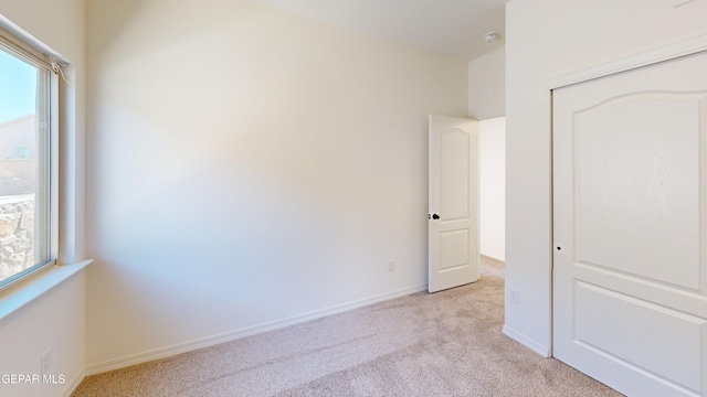 14764 Jack White Ave, El Paso, TX 79938 - unfurnished bedroom featuring light colored carpet and a closet