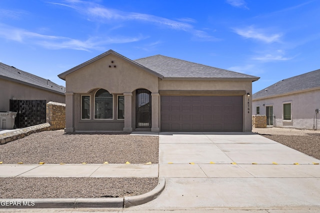 14764 Jack White Ave, El Paso, TX 79938 - view of front of house featuring an attached garage, driveway, and stucco siding
