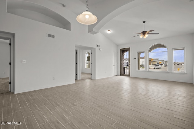2217 Tony Harper St, El Paso, TX 79938 - unfurnished living room with a ceiling fan, wood finished floors, and arched walkways