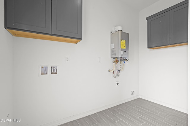 2217 Tony Harper St, El Paso, TX 79938 - laundry area with electric dryer hookup, cabinet space, hookup for a washing machine, light wood-style flooring, and water heater