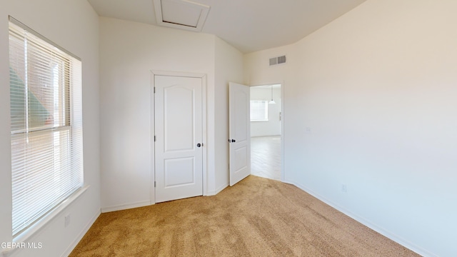 2237 Tony Harper St, El Paso, TX 79938 - unfurnished bedroom with baseboards, visible vents, carpet, and attic access
